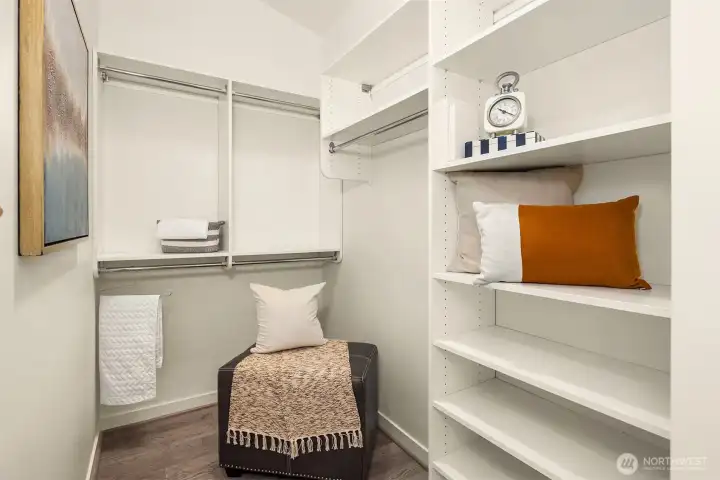 The primary walk-in closet has a nice storage system.
