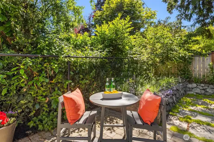 Just off the deck is this pavered patio, then beyond that is a flagstone-lined area with easy-to-maintain landscaping.