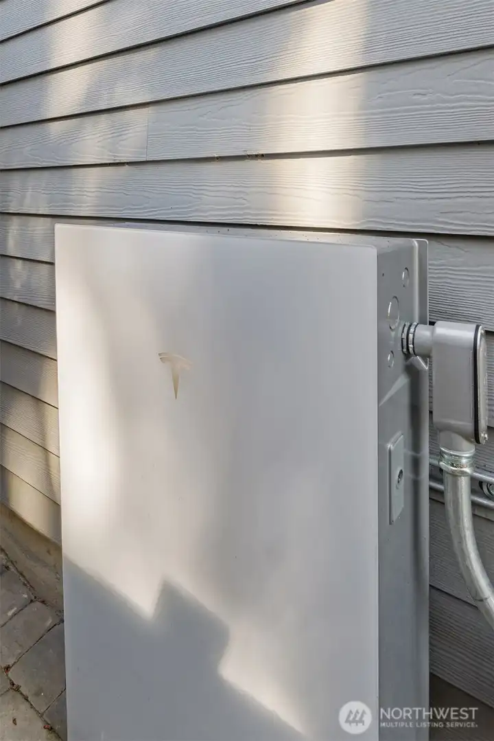 The 12-panel 290-volt photovoltaic solar energy system is paired with a Tesla Powerwall 3 battery storage system (the Tesla battery was installed in 2025). The setup allows homeowners to generate renewable electricity, store excess solar production for evening or peak-rate usage, and maintain backup power capability during grid outages. The integrated system can help reduce long-term utility costs, improve energy resilience, and support high-efficiency household operation.