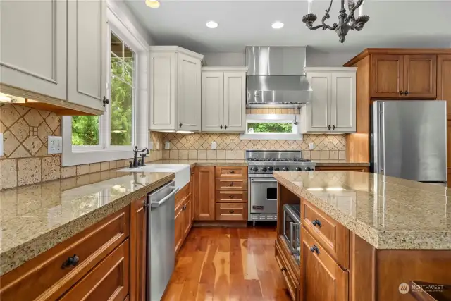Gorgeous gourmet kitchen boasts of granite countertops complemented by a custom tile backsplash.