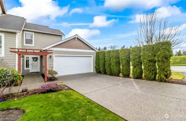 Light and bright end unit with 2-car garage and level driveway