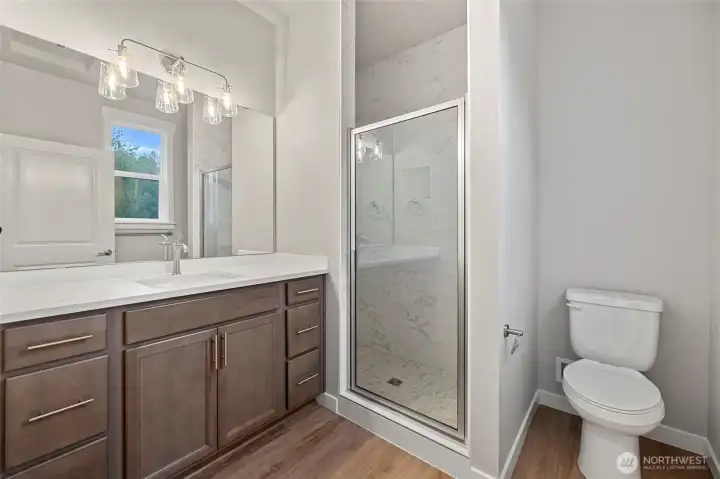 The primary bath has a tile shower and lots of counter space.