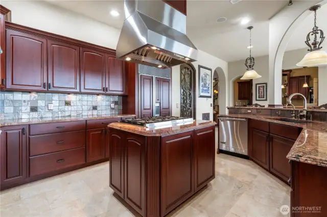 The kitchen features Viking appliances, a wine room with 8ft tall steel wine door, and spacious walk-in pantry. The cabinets throughout the home are solid cherry