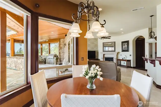The breakfast nook overlooks the pool and outdoor cooking area