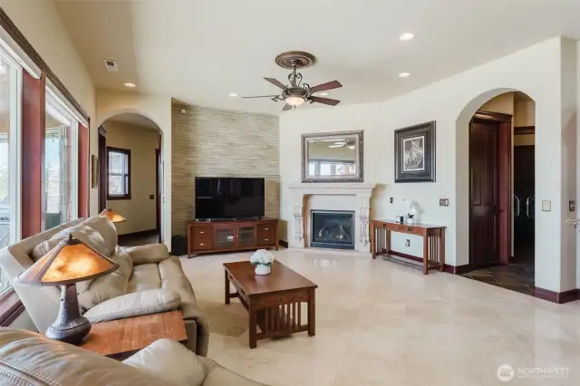 The family room is located near the kitchen and breakfast nook. There is a cozy gas fireplace with custom mantle
