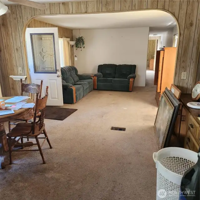 View from kitchen showing dinette on the left and hallway to bedrooms straight to your right