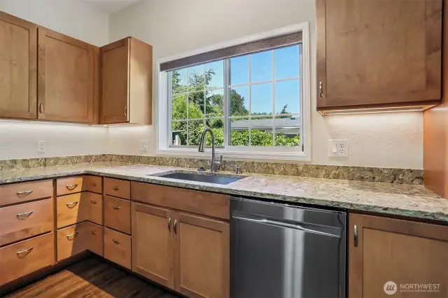 Updated kitchen with quartz, center island eating bar and stainless appliance package, opens to family room, eating area and dining room