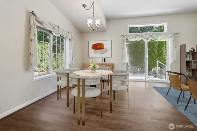 Family room and eating area opens to kitchen.  Sliding door opens to back patio that borders the community greenbelt and trail.  Virtually staged photo.