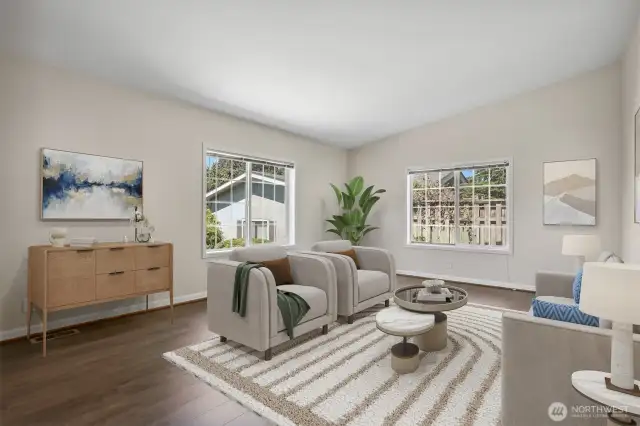 Formal living room with vinyl plank flooring and vaulted ceilings.  Virtually staged photo