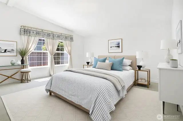 Master bedroom suite with vaulted ceilings, walk in closet and remodeled 5 piece bathroom with a walk in jetted bathtub.   Virtually staged photo.