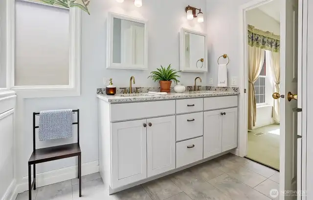Master bedroom suite with vaulted ceilings, walk in closet and remodeled 5 piece bathroom with a walk in jetted bathtub.   Virtually staged photo.