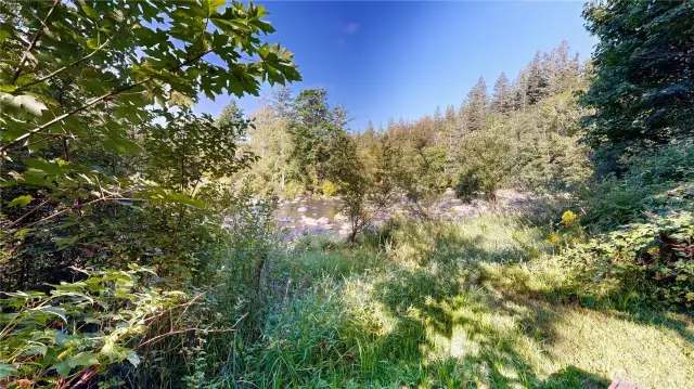 Breathtaking riverfront setting with lush greenery and tranquil views.