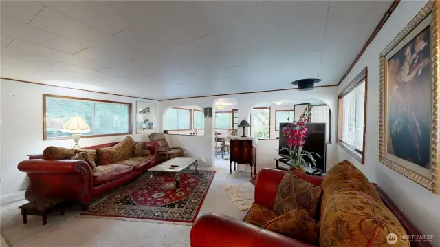 Spacious and inviting family room filled with natural light from large windows.