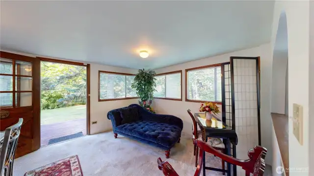 Cozy space sits just off the front entry, offering a warm welcome with flexible use—perfect for a reading nook, morning coffee spot, or quiet conversation area.