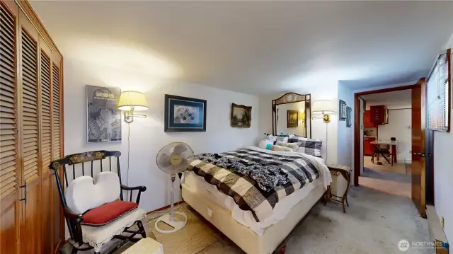 Comfortable primary suite featuring soft natural light, wall-to-wall carpet, and ample closet space.