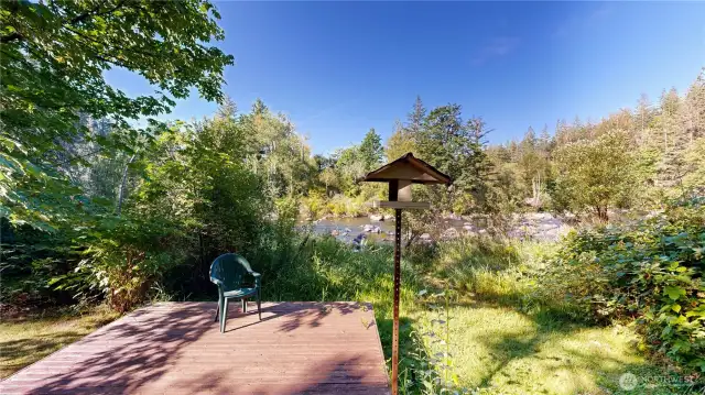 Tranquil yard space with a private viewing deck overlooking the scenic river.