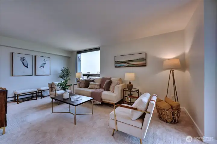 Another look at the gracious living area with large windows allowing natural light & views.