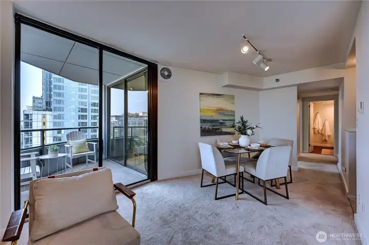 Lovely open dining area off the living area & kitchen with this fantastic circular floor plan & awesome covered corner deck with Space Needle views.
