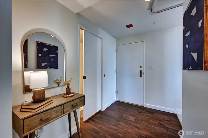 Here is the formal entry to the home, a spacious foyer with beautiful, laminated style wood flooring.