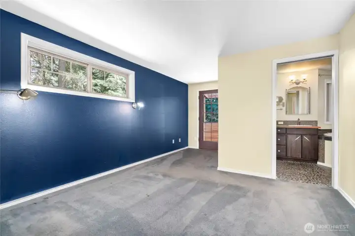 Upper primary bedroom with door to private deck.