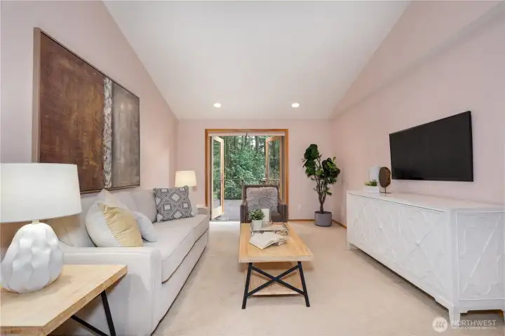 Living room with private entry leading out to deck.
