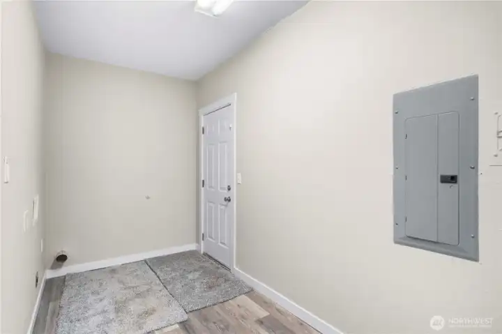 Utility room off kitchen with door to backyard.