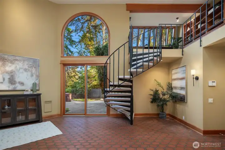 Entry with access to the outdoor patio and spiral staircase up to the loft