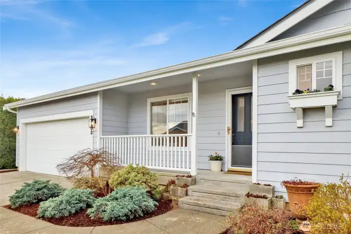 The charming covered front patio is the perfect cozy perch—just right for a rocking chair and your morning coffee or evening unwind.
