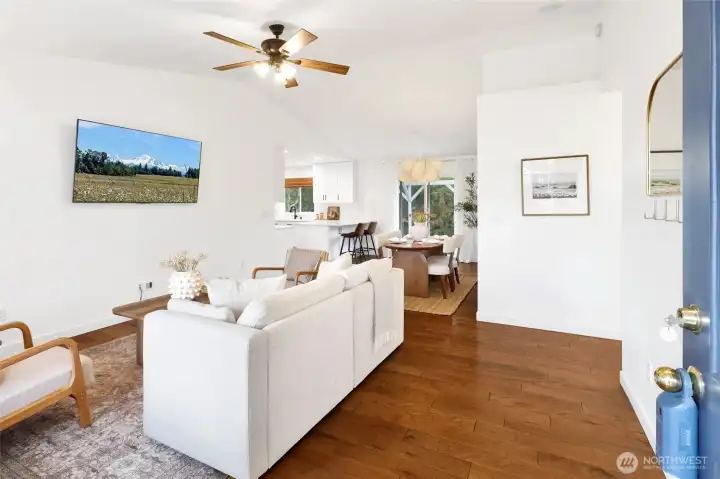 From the moment you step inside, you’re welcomed by a warm, open feel that instantly feels like home. Gorgeous distressed hardwood floors and soaring vaulted ceilings create a bright, inviting space that’s as stylish as it is comfortable.