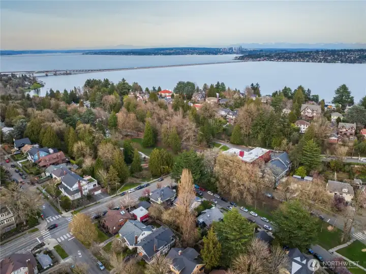 Looking east across the Mount Baker neighborhood toward Lake Washington, with the I-90 floating bridge cutting across the water. Situated directly on Mt. Baker Blvd, the home is moments from the neighborhood's best amenities — including Mioposto, Velvet Elk Cocktail Bar, and Bright Spot Cafe — along with a nearby playground and pickleball courts, all within easy reach of this convenient, community-centered location.