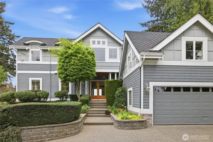 Welcoming entrance with large driveway and 3 car garage.