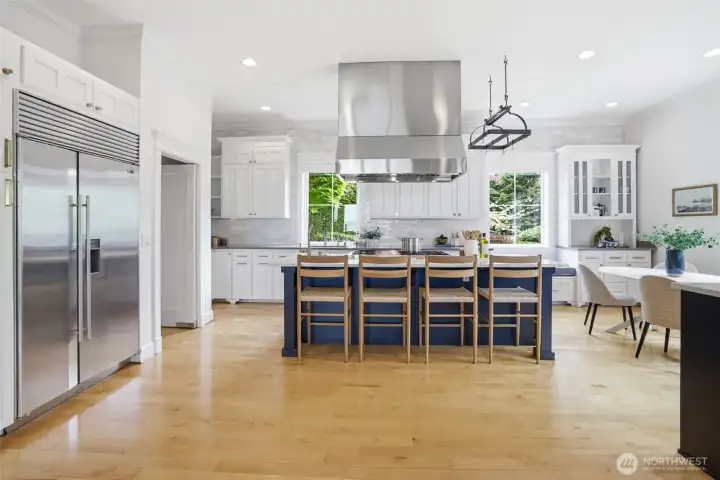 Open kitchen, high end appliances, and eating space back right.