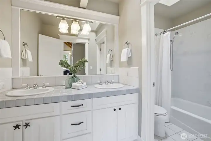 Upper floor bathroom with tub and shower.