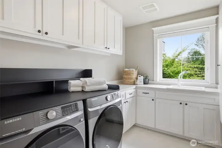 Upper floor laundry and attic storage access.