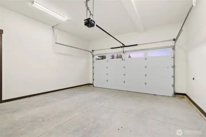 Spacious 2 car garage with separate side door to garbage room Spacious 2 car garage with separate side door to garbage room