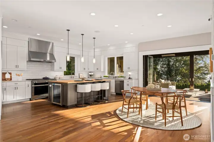 Chef's kitchen provides seamless connection between the chef's kitchen, casual dining area, and outdoor living spac