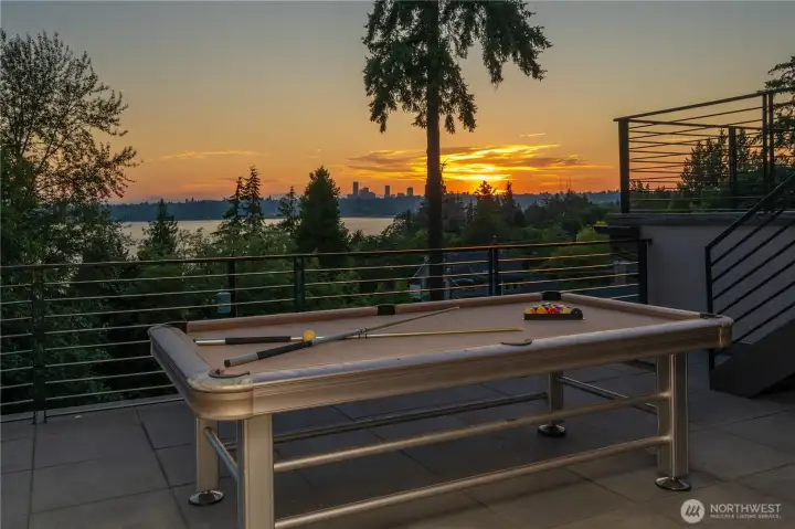 Designed as an outdoor extension of the primary suite, the expansive two-level terrace creates a private sanctuary above it all. Gather around the fire pit, enjoy a game of pool, or simply relax while overlooking Lake Washington, the Seattle skyline, and spectacular sunsets