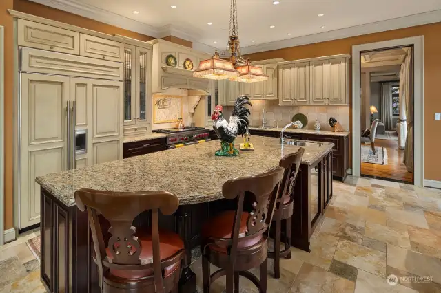 Chef’s kitchen features granite, stone and tile accents.