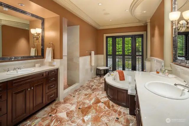 The Primary Bath has only the finest finishes including custom Marble Floors, In-Floor Heating, Double Head Shower with Bench, Heated Towel Bar, spa tub & two custom Walnut Vanities.