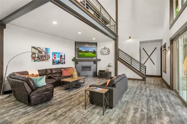 Large, open living space with vaulted ceilings and custom metal railings!