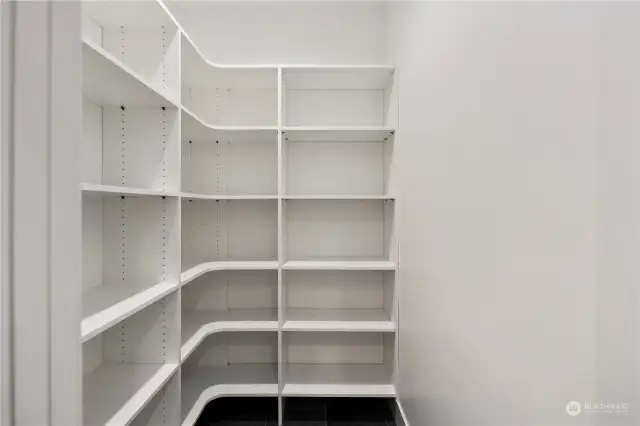 Walk-in pantry with built in shelving.