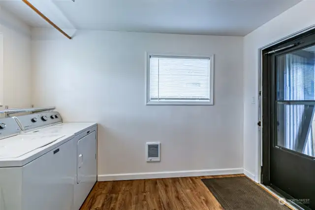 Laundry room off the kitchen opens to rear covered porch & backyard.