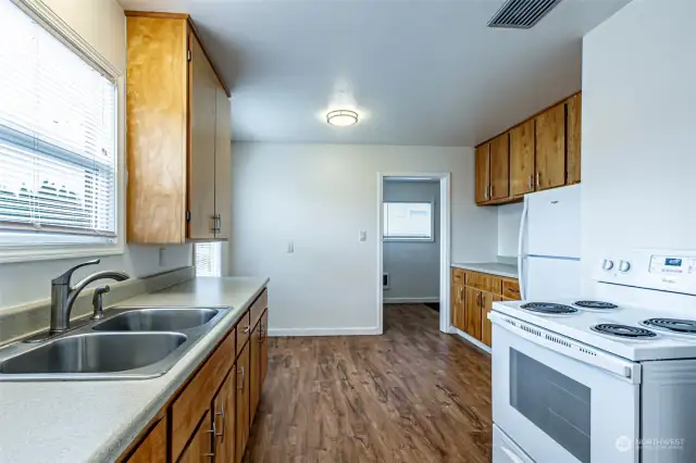 Wide galley kitchen with eating nook.