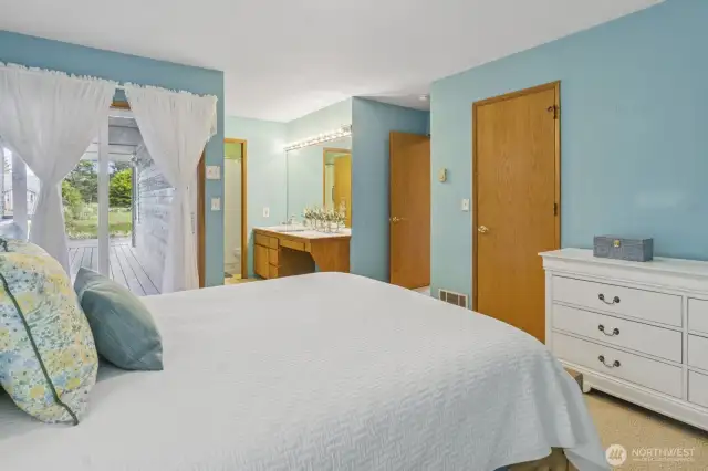 Beautiful primary bedroom featuring a vanity area with ample space for a makeup station
