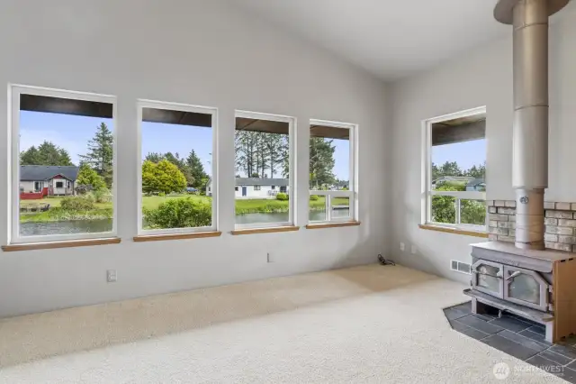 Stunning picture windows frame serene canal views and flood the space with natural light