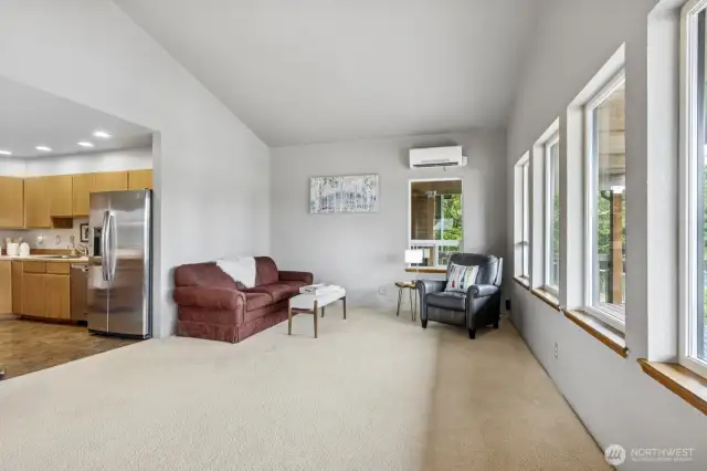Expansive living room with scenic views of the tranquil canal.