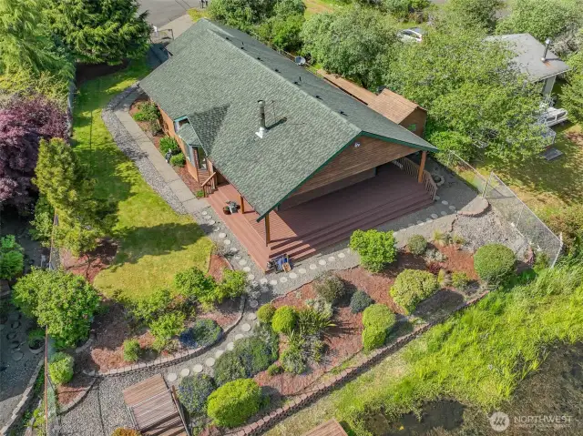 Aerial drone view of the entire property showcases exquisite landscaping and a roof just 7 years old.