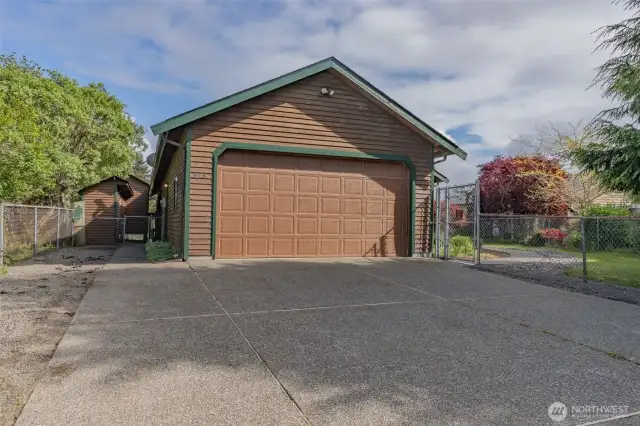 Two-car attached garage with plenty of driveway space for additional vehicles.
