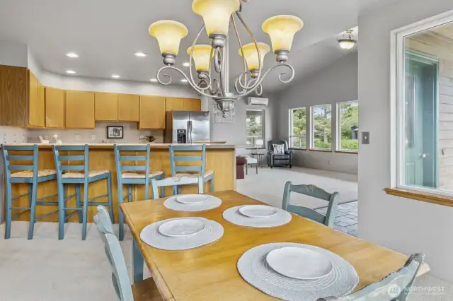 Open view from the dining room into the kitchen and living room, creating a seamless and inviting layout