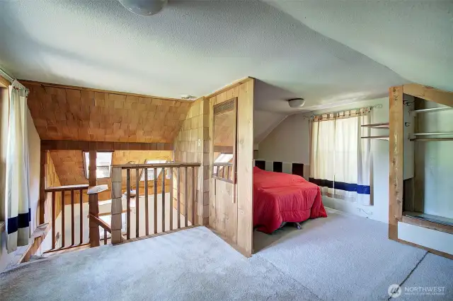 A loft bedroom is featured in the house